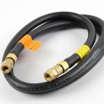 Coiled ORCA M125TM hose with brass fittings, showcasing the male and female ends