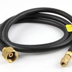 Coiled ORCA M125TQ hose, showing the brass fittings on each end on a white background