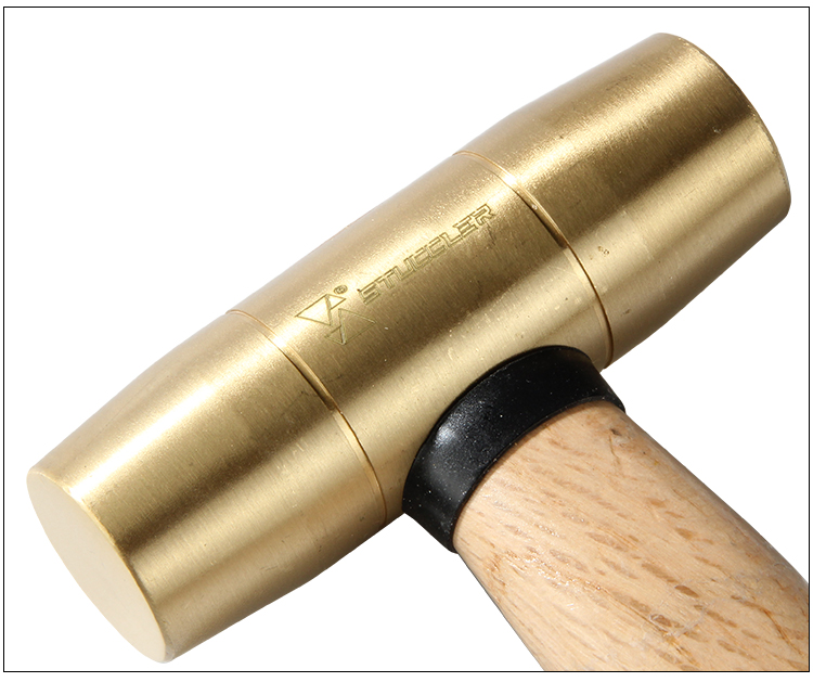 Detailed close-up of the brass head and wooden handle connection of a Stuccler jeweler's mallet
