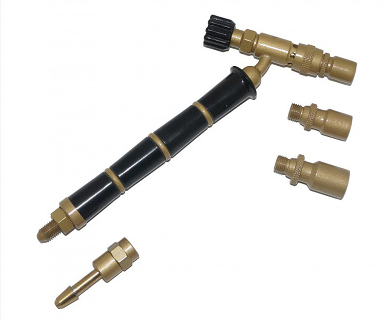 he ORCA M75 CTG torch kit with a black handle and multiple golden accessories, scattered on a white background