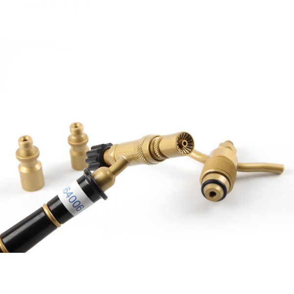 The open box of the ORCA M75 CPA welding torch kit, showing the torch, hose, accessories, and product manual inside