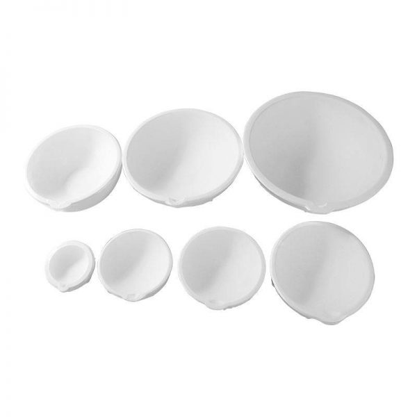 Top-down view of six white Stuccler melting crucibles of varying sizes, laid out on a white surface