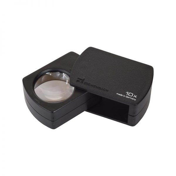A black Eschenbach pocket magnifier, unfolded to show the 10x lens and an open end.