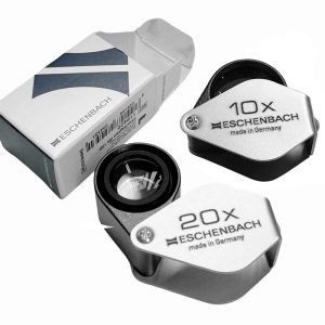 A set of Eschenbach 10x and 20x folding magnifiers with their product boxes.