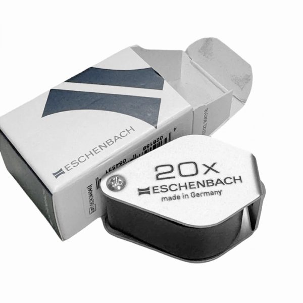 An Eschenbach 20x folding magnifier next to its product box.