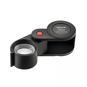 Eschenbach Aplanat 10x folding magnifier, shown partially unfolded with the lens extended.