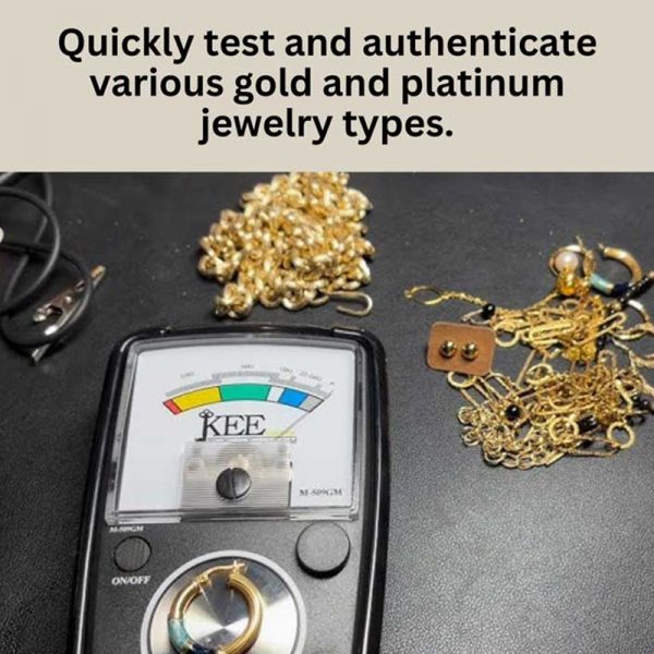 The KEE tester on a black surface next to a pile of gold and platinum jewelry.